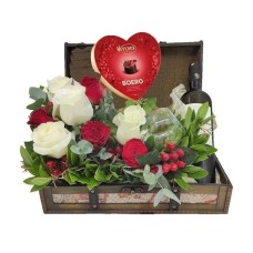 Wooden chest with wine, two glasses and chocolate