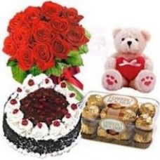 12 Red Roses Bouquet, 16 Ferrero Chocolates, 1 Kg Black Forest Cake And Teddy Bear