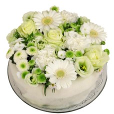 White and green flower cake (Medium white and green floral cake on a glass plate)