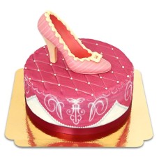 Pink deluxe cake with chocolate shoe and ribbon