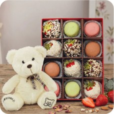 Strawberries in white and milk chocolate with coconut and nut topping and macaroons + teddy bear