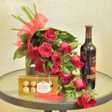 Red roses with a bottle of wine and truffles