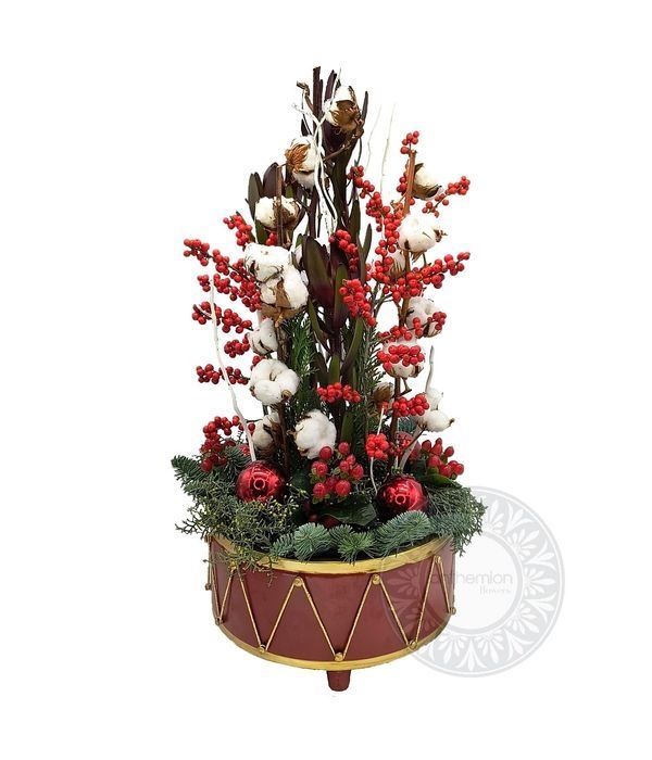 Festive flower arrangement in a metallic drum