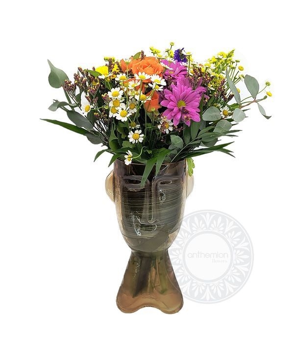 Happy flowers in a glass head
