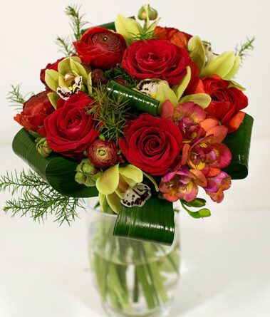 Spherical bouquet of red roses and orchids