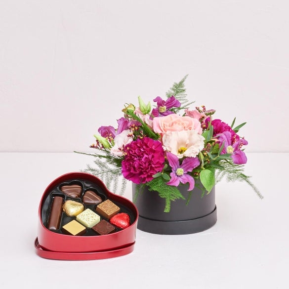 Florist's creative selection in a box with a chocolate heart