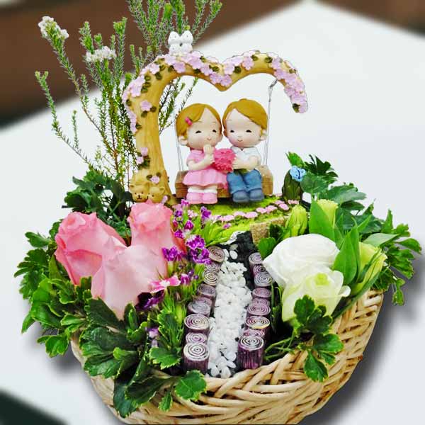 Couple On A Tree Swing Resin Figurine And  3 Peach Roses In Basket.