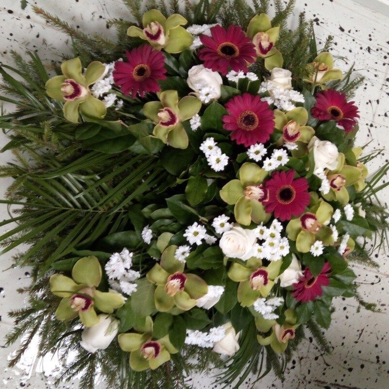 Memorial wreath with green, red, white flowers