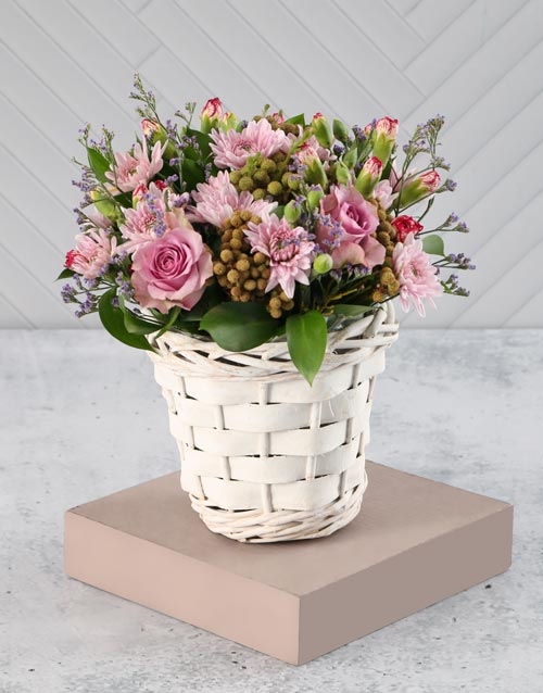 Pink And Purple Blooms In A White Basket