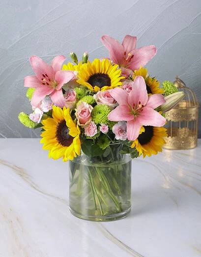 Bright Mix of Sunflowers in a Large Glass Vase