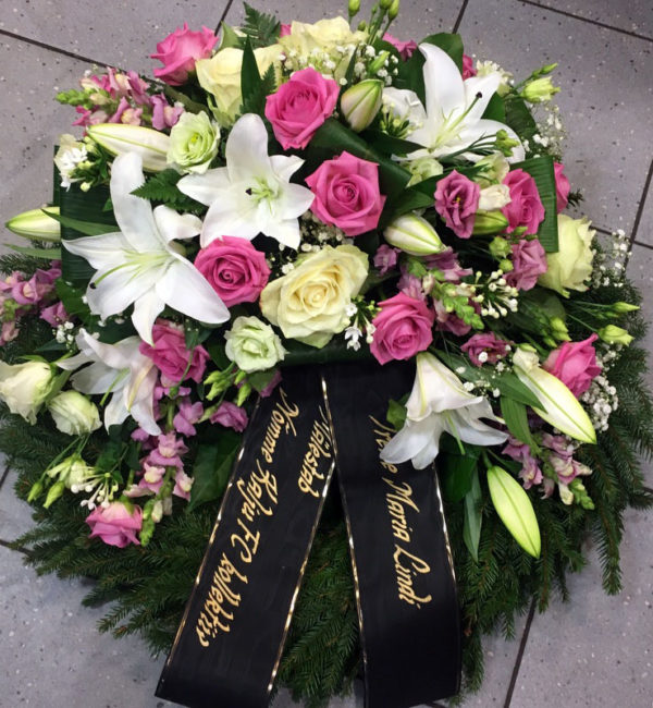 Large funeral wreath: pink and white roses, lisianthus, lilys
